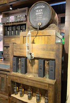 an old fashioned wooden shelf with bottles on it and a sign that says jameson black barrel