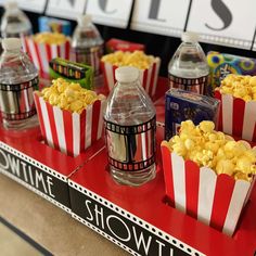 popcorn and water bottles are on display at a movie themed store in the united states