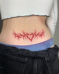 a woman's stomach with red ink on it