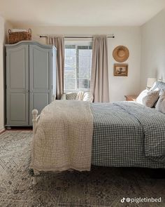 a bedroom with a bed, dresser, and window in it's center area