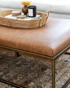 a coffee table with a tray on top of it and a mug in the middle