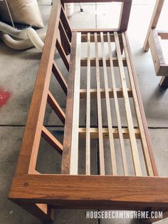 a wooden bed frame sitting on top of a floor