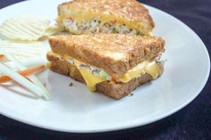 a white plate topped with a sandwich and chips