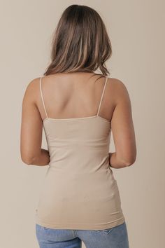 Smooth and shape with this basic camisole! Our Nikibiki nude cami features a long, form-fitting silhouette with a round neckline. Now available in TWO other colors including White & Black! Fitted Camisole With Built-in Bra, Basic Tank Top With Spaghetti Straps And Built-in Bra, Basic Cami Tank Top With Built-in Bra, Basic Camisole With Built-in Bra, Seamless Fitted Tank Top With Spaghetti Straps, Fitted Seamless Tank Top With Spaghetti Straps, Second-skin Tank Top With Spaghetti Straps, Seamless Fitted Camisole Tank Top, Basic Fitted Cami Tank Top