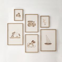 six framed pictures hang on the wall above a bed with a teddy bear and other items