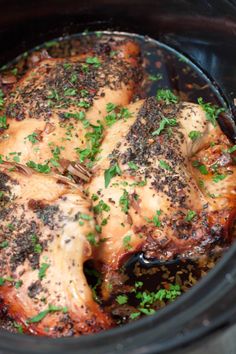 the chicken is cooked in the slow cooker and garnished with parsley