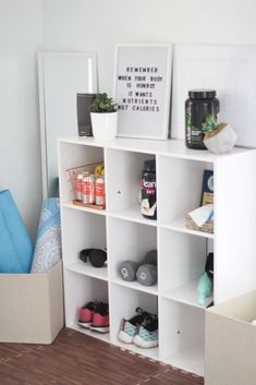 a white shelf filled with shoes next to a mirror