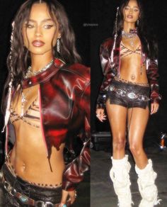 a woman in short shorts and boots is posing for the camera with chains on her body