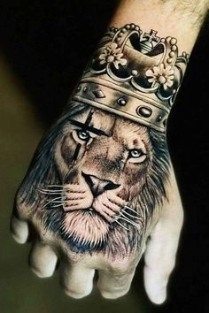 a hand with a lion wearing a crown on it