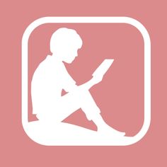 a person sitting on the floor with a book in their lap and reading it,