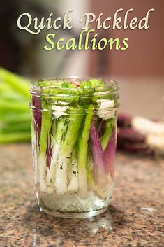 pickled scallions in a mason jar on a countertop with the words quick pickled scallions