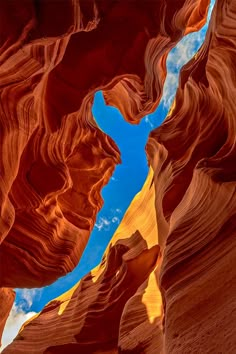 an image of the inside of a canyon with blue sky and clouds in the background