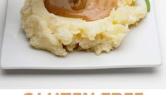 a white plate topped with mashed potatoes covered in gravy