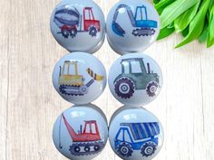 four glass knobs with construction vehicles painted on them