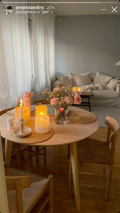 a table with candles on it in front of a couch