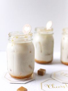 three mason jars filled with marshmallows and cookies