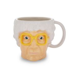 Enjoy your favorite beverage in style with this oversized The Golden Girls ceramic mug! This fully sculpted 3D mug features the face of the wise-cracking Sophia! Fun and functional, this mug is great for using around the house, at the office, parties, and more! Officially licensed. A Toynk Toys exclusive! | Silver Buffalo The Golden Girls Sophia Petrillo Sculpted Ceramic Mug | Holds 20 Ounces Ceramic in Brown / White / Yellow, Size 5.5 H in | Wayfair Sophia Petrillo, Dukes Of Hazard, 3d Mug, Travel Coffee Cup, The Golden Girls, Large Coffee Mugs, Large Coffee, Gal Pal, Yellow Cream