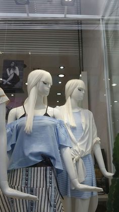 three mannequins dressed in blue and white clothing