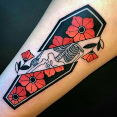 a tattoo on the arm of a woman with flowers and a skeleton in it's body