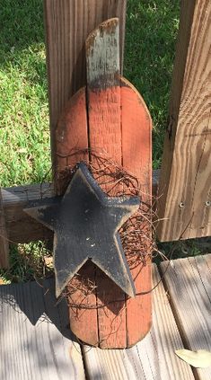 a wooden fence with a metal star on it and a hammer sticking out of the top