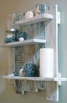 two wooden shelves with candles and other items on top of them, one shelf is made out of pallet boards