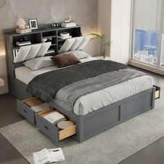 a bed with drawers underneath it in a room next to a window and a book shelf