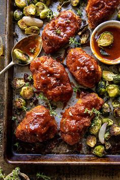 an overhead view of some meat with sauce and brussel sprouts on the side