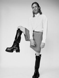 black and white photograph of a woman in boots