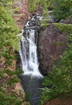 a waterfall in the middle of some trees