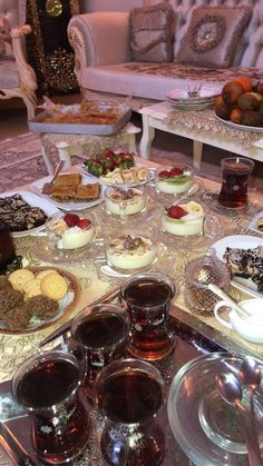 a table filled with desserts and tea cups