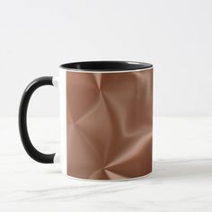 a black and white coffee mug sitting on top of a marble countertop next to a wall