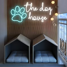 the dog house has two beds and a neon sign on the wall above it that says,