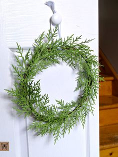 a wreath is hanging on the front door