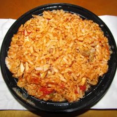 a black bowl filled with rice on top of a table