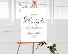 a sign that says pick a seat not a side, with flowers on the easel