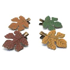 Your customers will fall for this hair clip. They won't want to leaf home with out it.Leaf measures 1-1/4" x 1-1/8" at widest points.On alligator clip.Made of antiqued bronze. This hair accessory comes in the following colors: Marsala Foliage Dijon Ginger Leaf Hair Clip, Pine Jewelry, Wicked Musical, Mint Gold, Fall Leaf, Yellow Earrings, Metal Leaves, Hair Painting, Color Pick