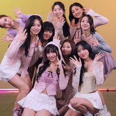 a group of young women posing together for a photo with their hands in the air