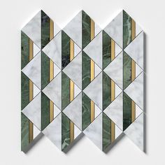 three white and green marble tiles with gold lines on the sides, all in different shapes