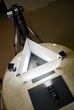 a camera is sitting on top of a table with a square object in the middle