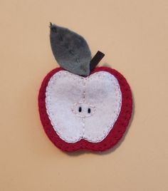 an apple ornament with a gray bird on top