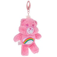 a pink teddy bear with a rainbow on it's chest is hanging from a keychain