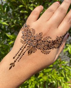 a woman's hand with hennap on it and flowers in the middle