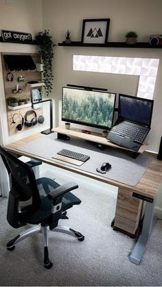 a computer desk with a laptop, monitor and keyboard sitting on top of it in front of a window