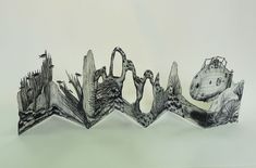 an intricately designed sculpture is shown against a white background with black and white images