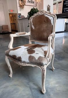 an old chair with cow hide upholstered on it