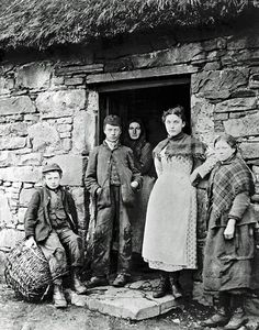 an old black and white photo of people standing in front of a door