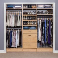 an organized closet with clothes and shoes