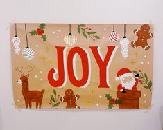 a christmas banner hanging on the side of a wall