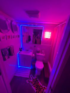 a bathroom with purple lights and a zebra rug on the floor in front of it