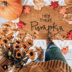 someone standing in front of a welcome mat that says hey there pumpkin